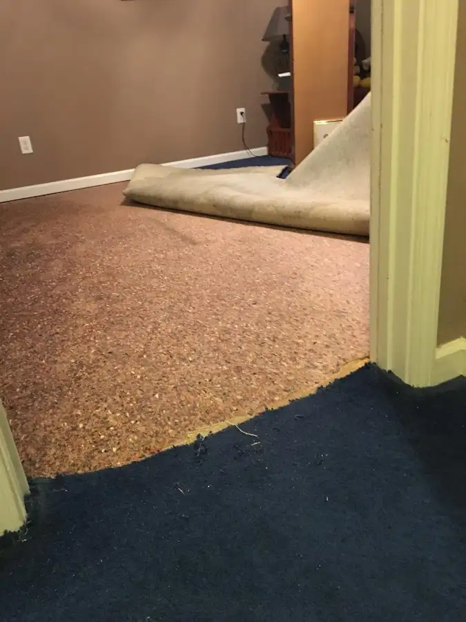 Carpet pad removal revealing water damage during Water Mitigation Services in Port Allen